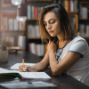 Student writing a dissertation on a laptop